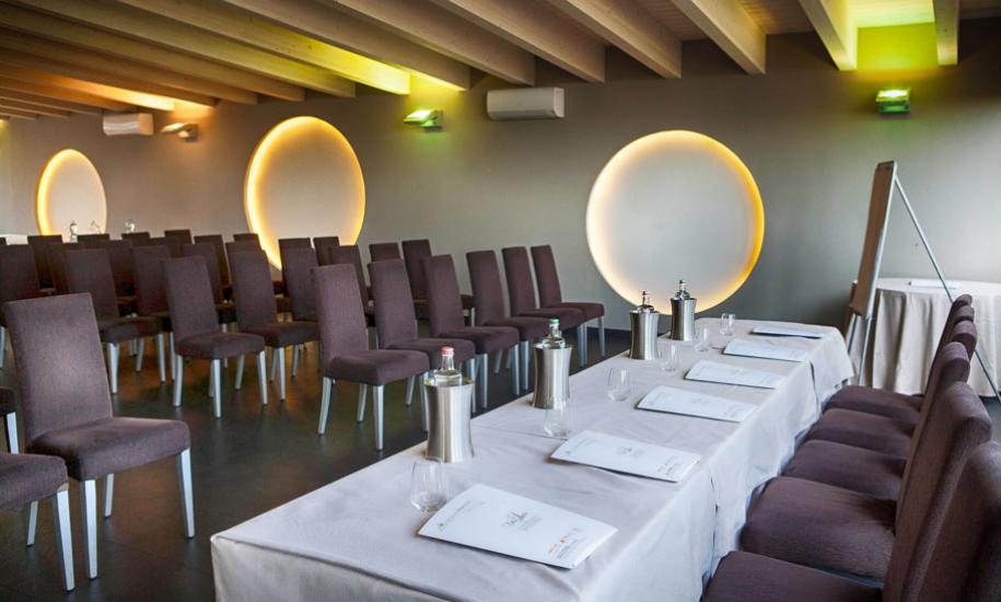 Modern conference room with brown chairs and circular lighting.